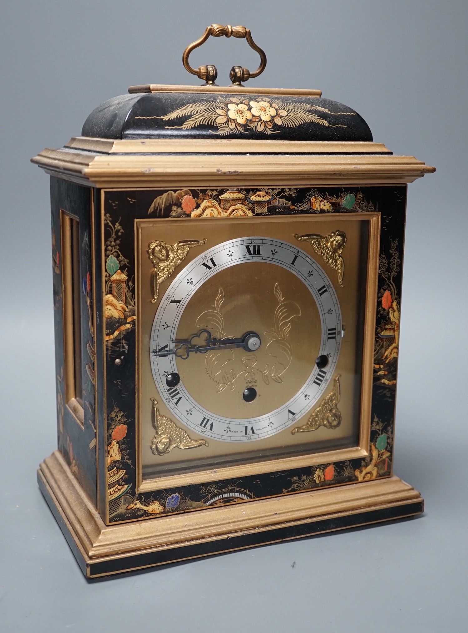 A F.W. Elliott japanned mantel clock, with chiming mechanism, 32 cms high